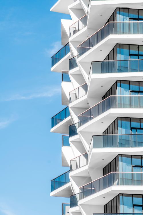 Free A sharp, futuristic architectural design showcased against a clear blue sky in Dubai. Stock Photo