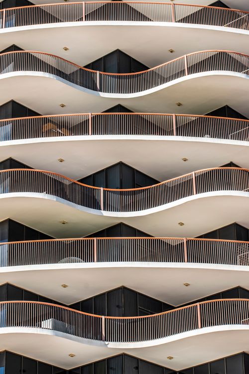 Free Stylish curved balconies on a modern Dubai apartment building showcasing architectural design. Stock Photo