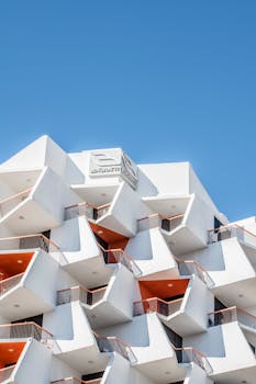 A geometric architectural building in Dubai under a clear blue sky.