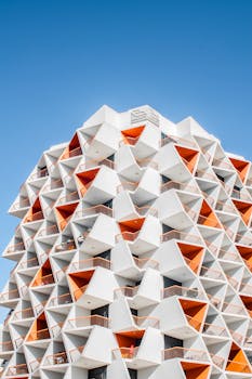 Explore the futuristic and geometric architectural marvel in Dubai with vibrant orange and white patterns.