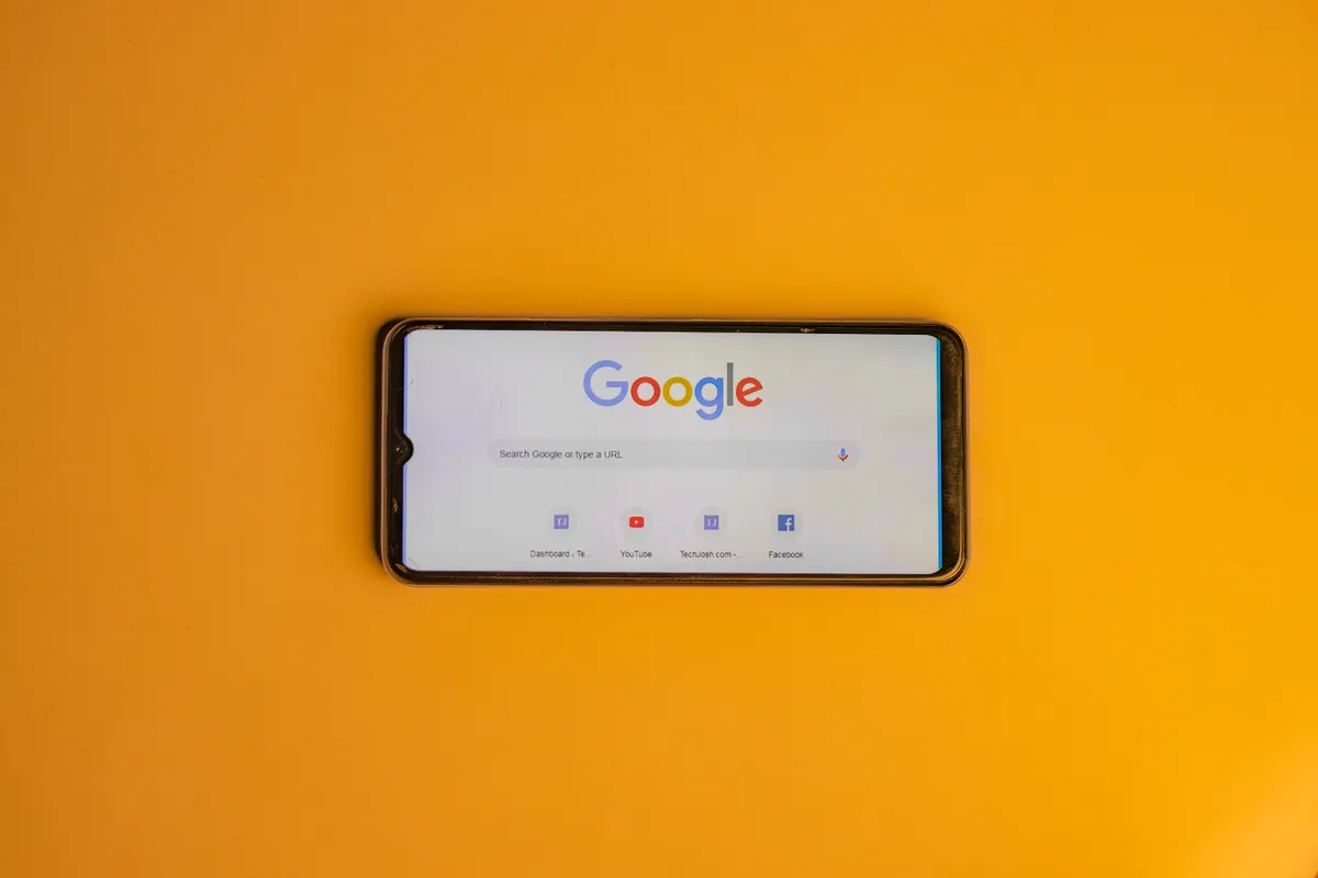 Smartphone showing Google search, useful for finding the best ai content generator tools.