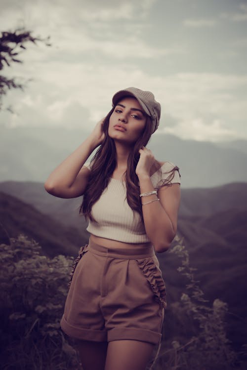 Free Young Woman in a Casual Summer Outfit Posing Outdoors  Stock Photo