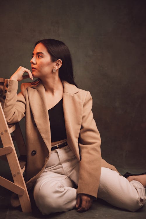 Young woman in a Fashionable Outfit Posing in Studio 