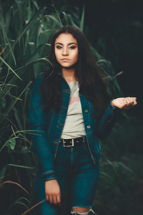 Young Brunette in a Denim Outfit Posing Outdoors 