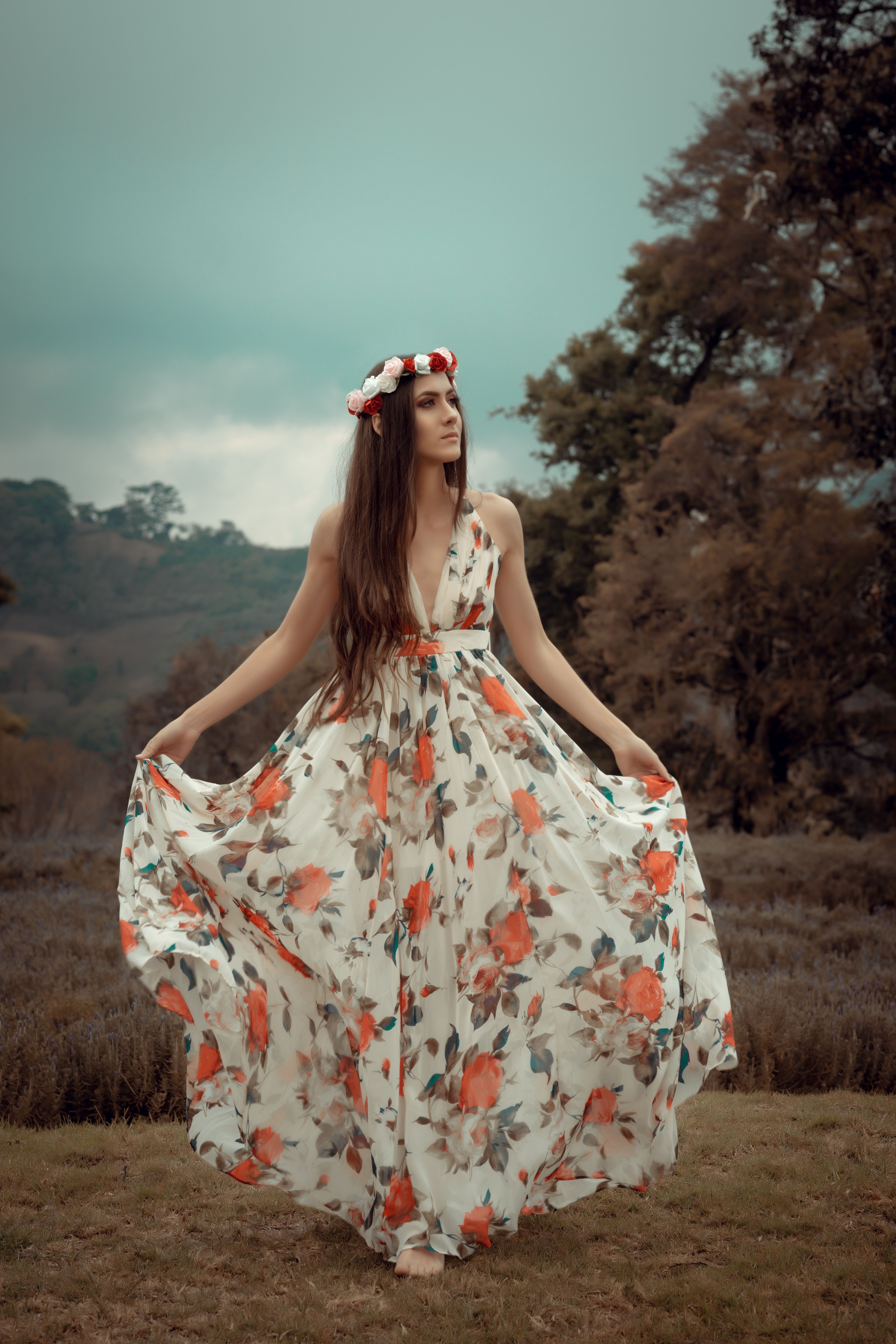 Young Woman in a Dress with Floral Pattern and a Flower Crown on a ...