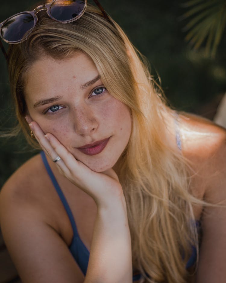 Portrait Of Young Woman With Sunglasses On Head