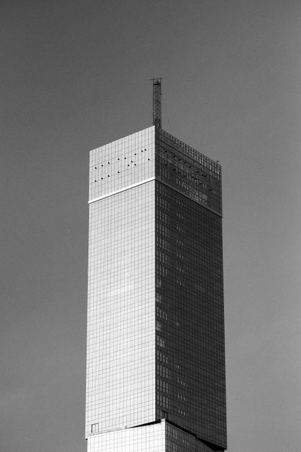 High-rise glass skyscraper captured in elegant black and white photography.