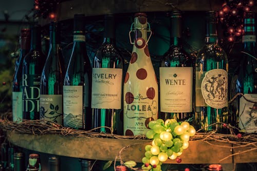 Free Close-up Photo of Assorted Wine Bottles on Shelf Stock Photo