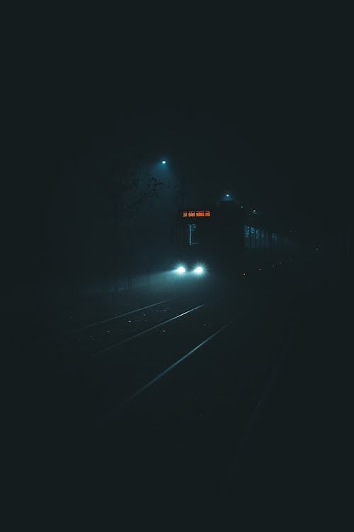Cinematic Shot of Tram Riding with Headlights On on a Foggy Night ...