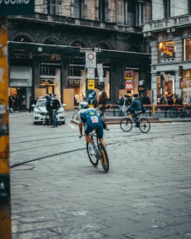 Professional cyclist racing through a busy urban area during a city bike competition.