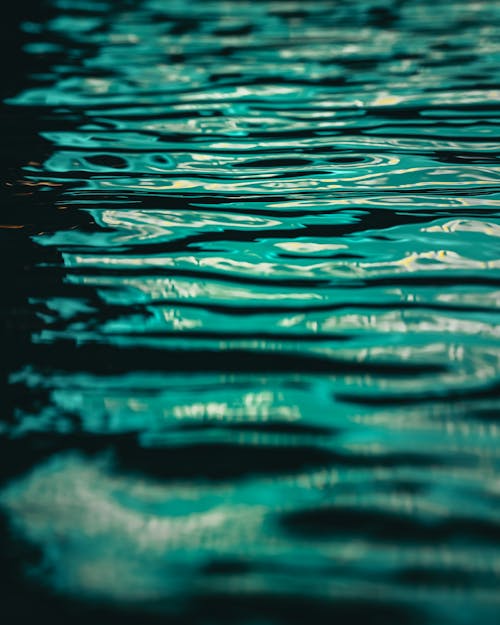 Closeup of a Water Surface with Ripples and a Turquoise Reflection