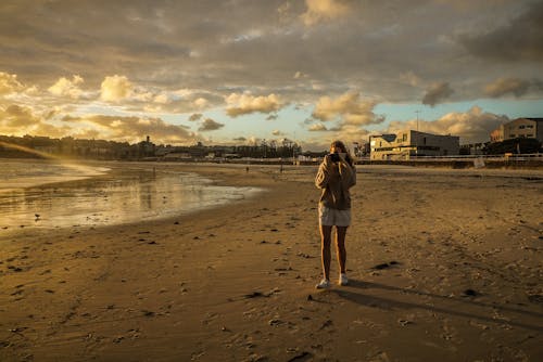 Free Woman Standing On Beach Shore Stock Photo