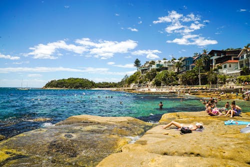 People Sunbathing At The Beach