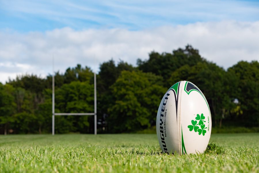 Rugby ball resting on a grass pitch