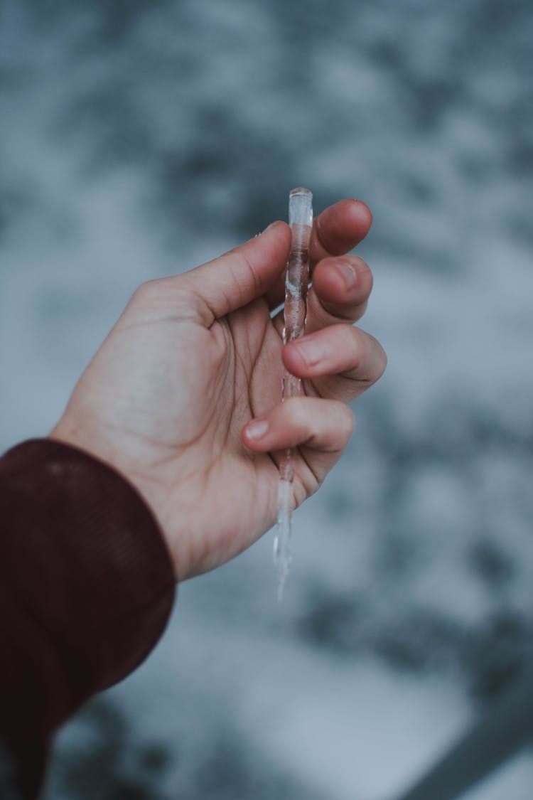 Person Holding Icicle