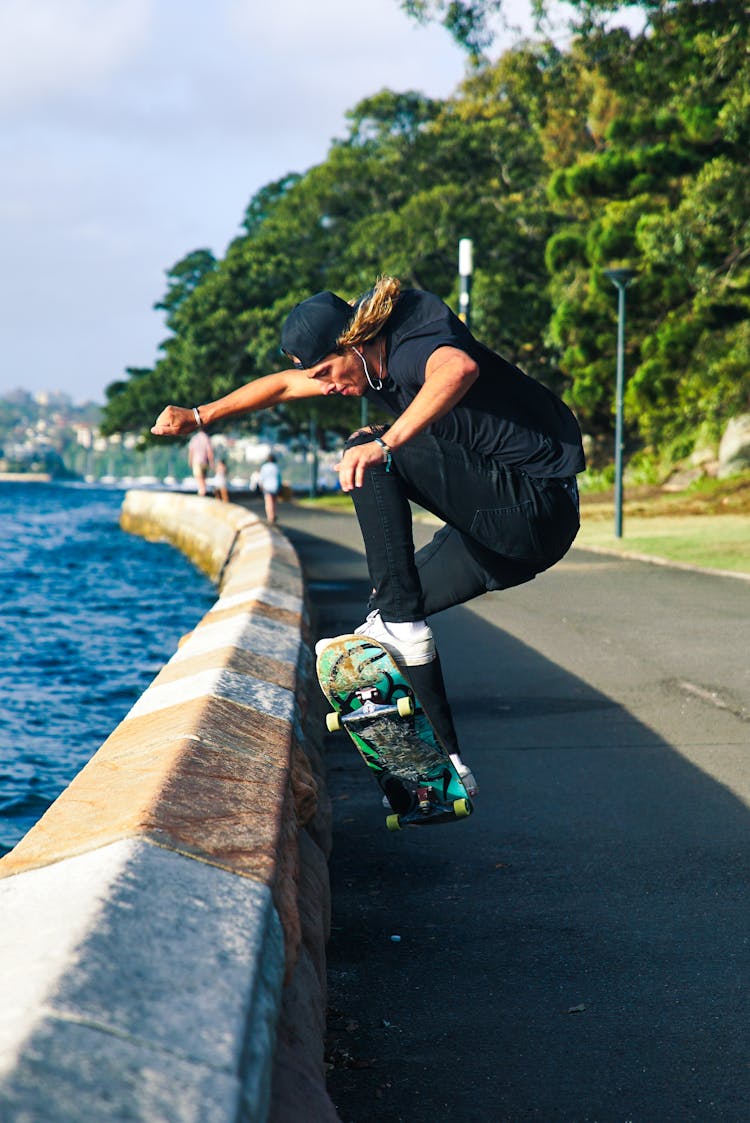 Person Skateboarding Near Lakeside