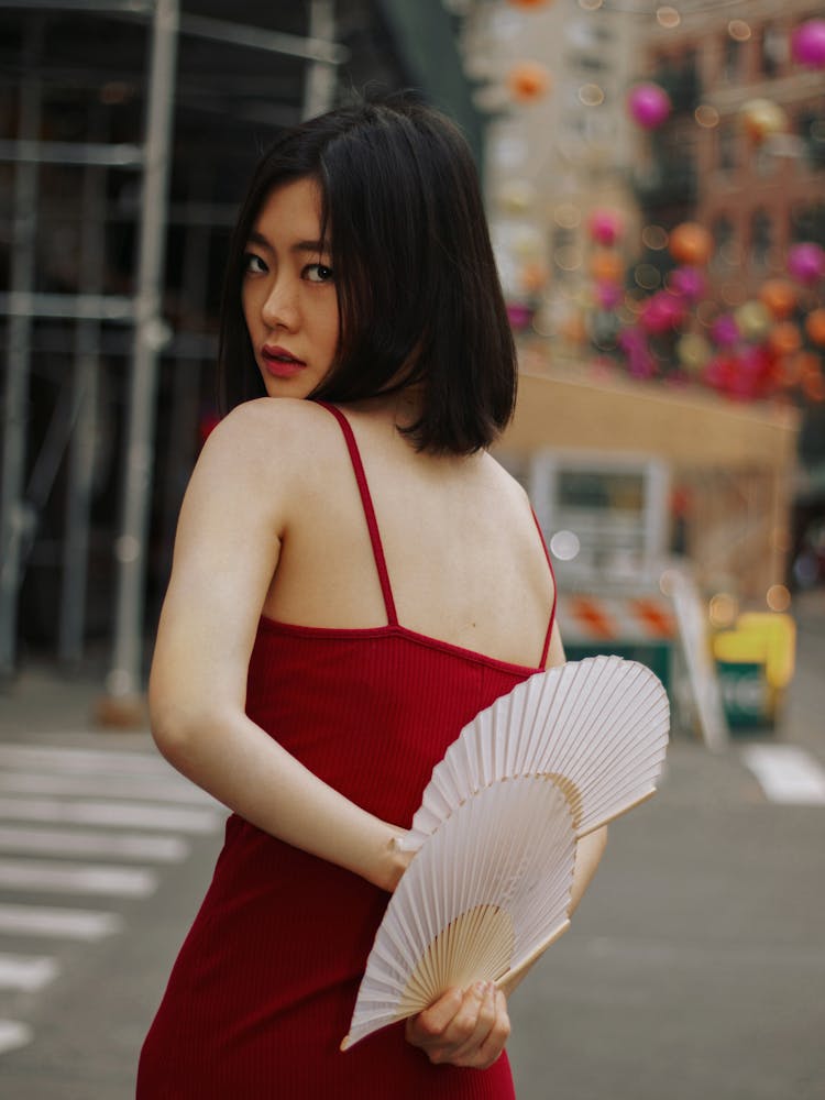 Woman Posing In Red Dress And With Fan