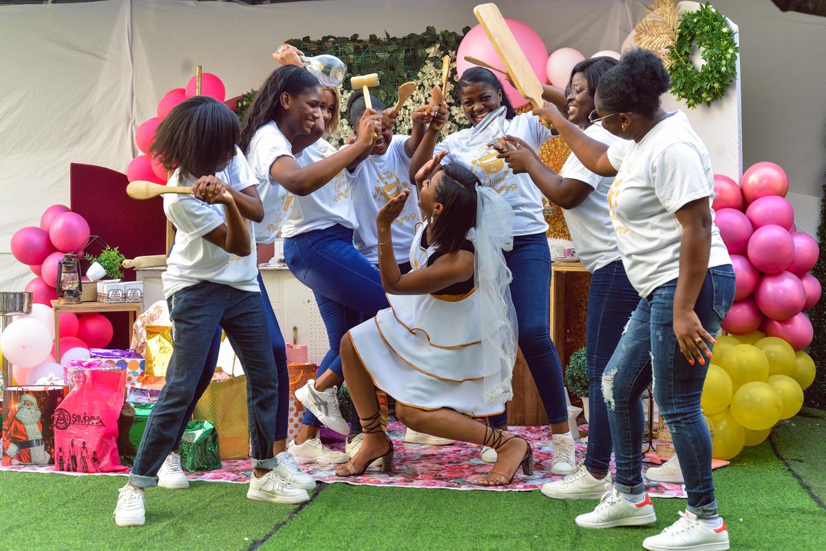Bride with friends playing a party game at her bridal shower