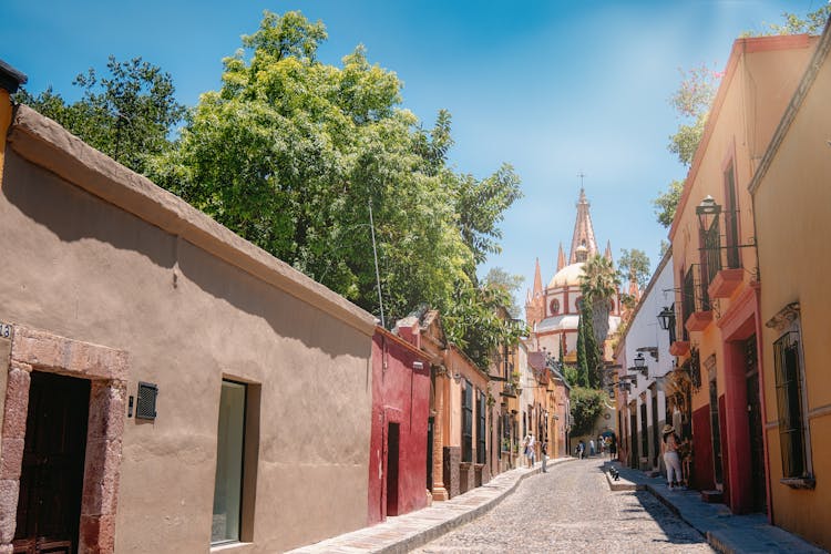 Cobbled Street Between Houses Leading To Cathedral In San Miguel De Allende