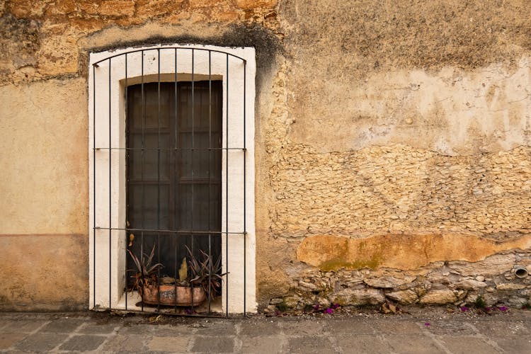 Window With Flower Pot In An Old Street