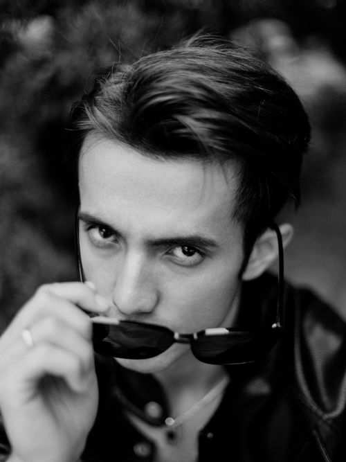 Free Stylish black and white portrait of a young man in sunglasses, posing with confidence. Stock Photo