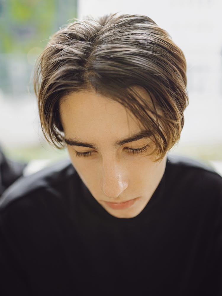 Close-up Of Young Man In Black Clothes