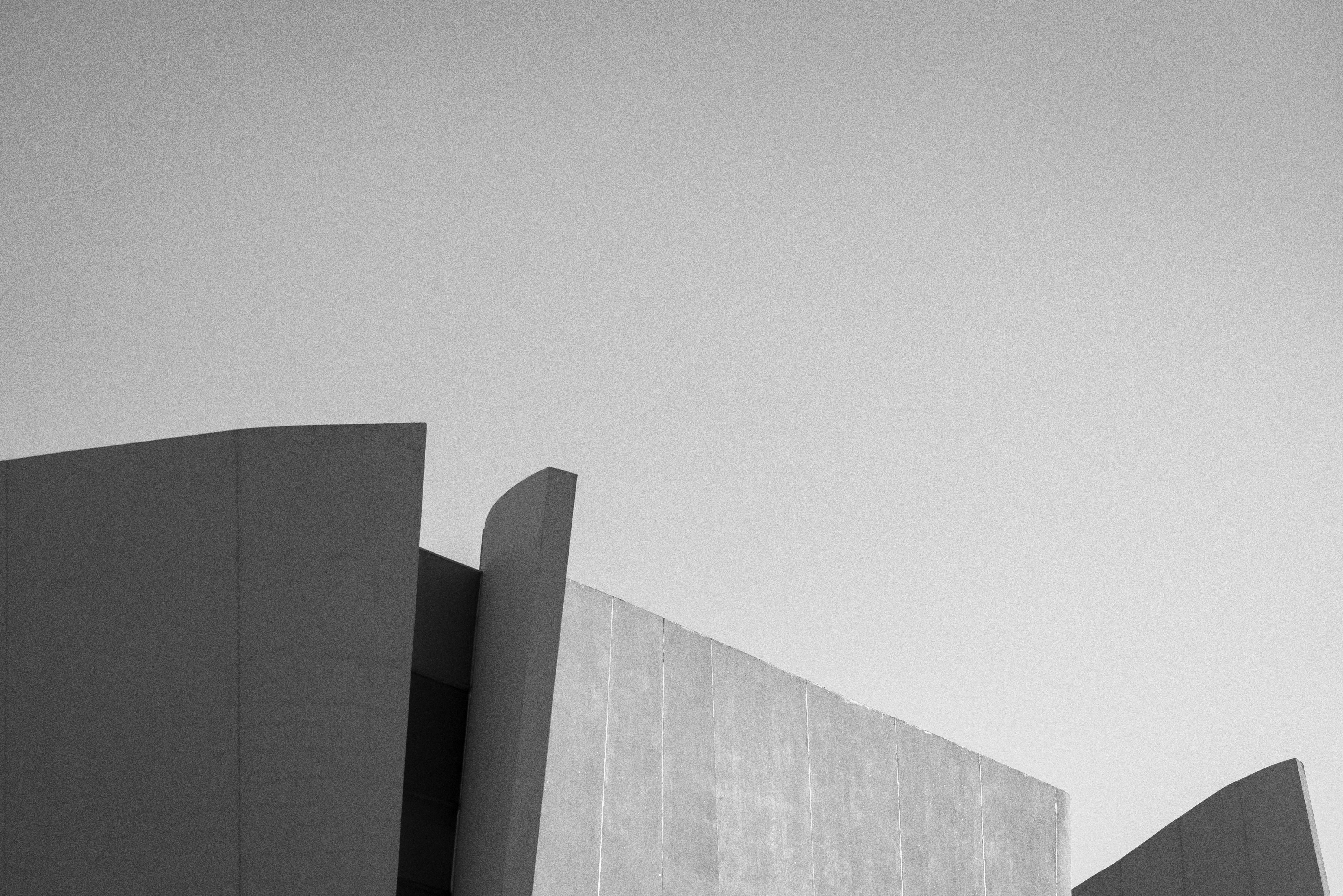 Black and white modern building against a clear sky.