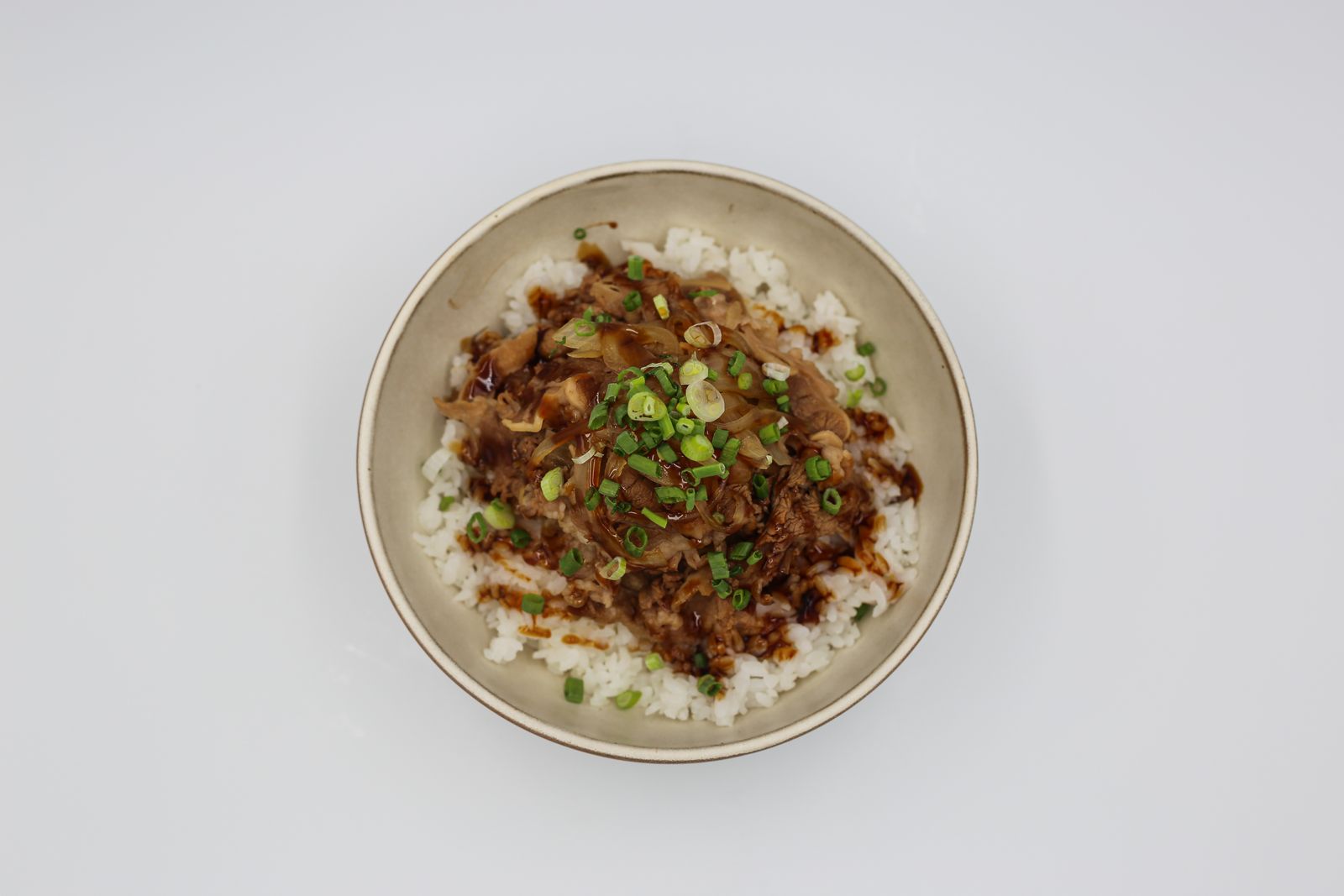 Ground beef and rice protein bowl with green onions