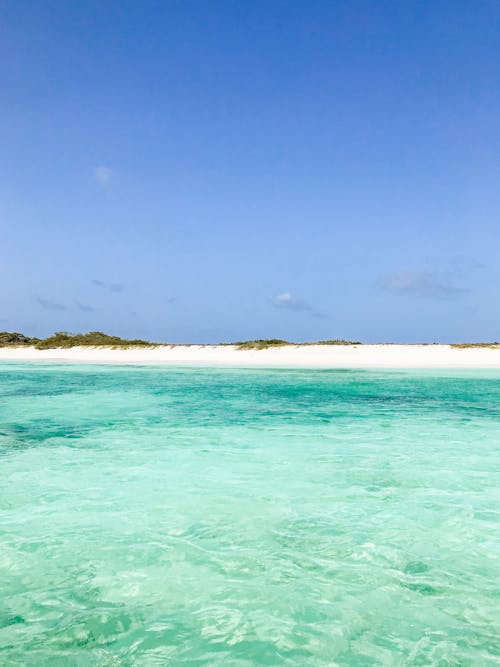 Tranquil Seashore Landscape with Turquoise Water and White Sand Dunes