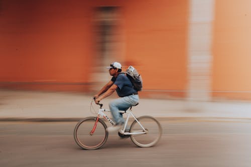 Man on a Bicycle Riding Down the Street
