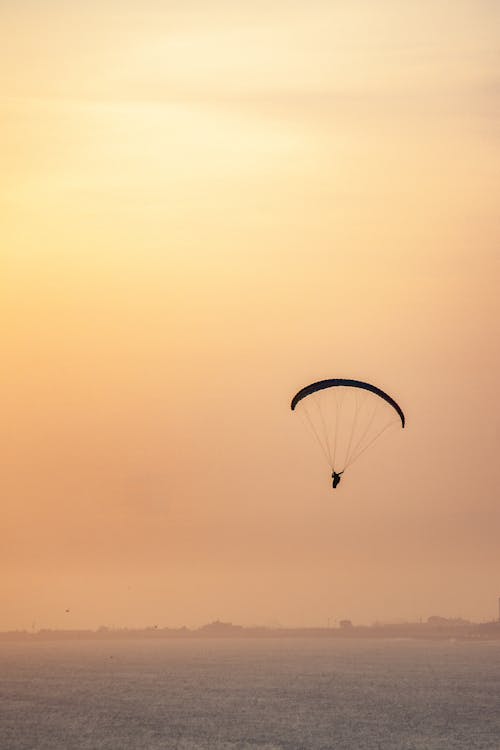 Paragliding over the Sea at Sunset