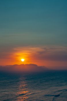Capture of a beautiful sunset over the ocean with vibrant orange and blue hues.
