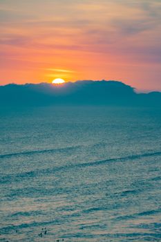 Beautiful ocean sunset with vibrant colors and silhouetted horizon, capturing serene coastal scenery.