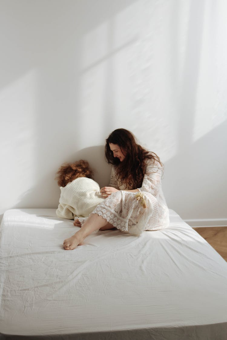 Mother With Daughter On Mattress