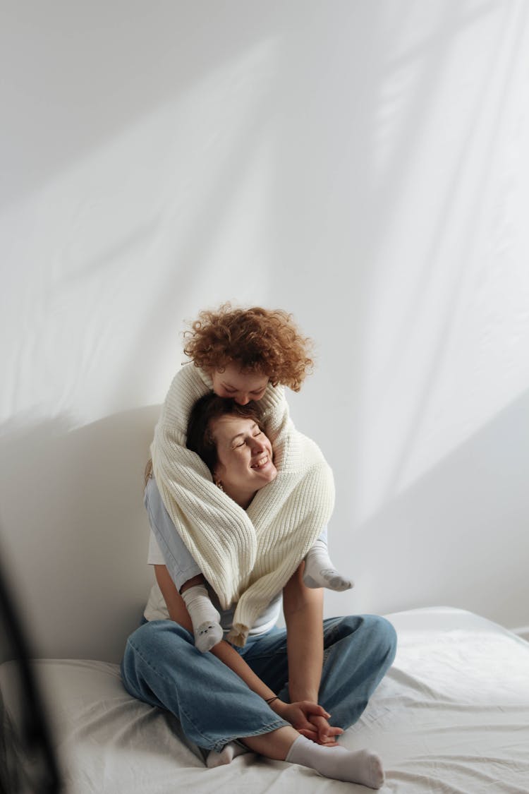 Daughter Sitting On Her Mother Shoulders