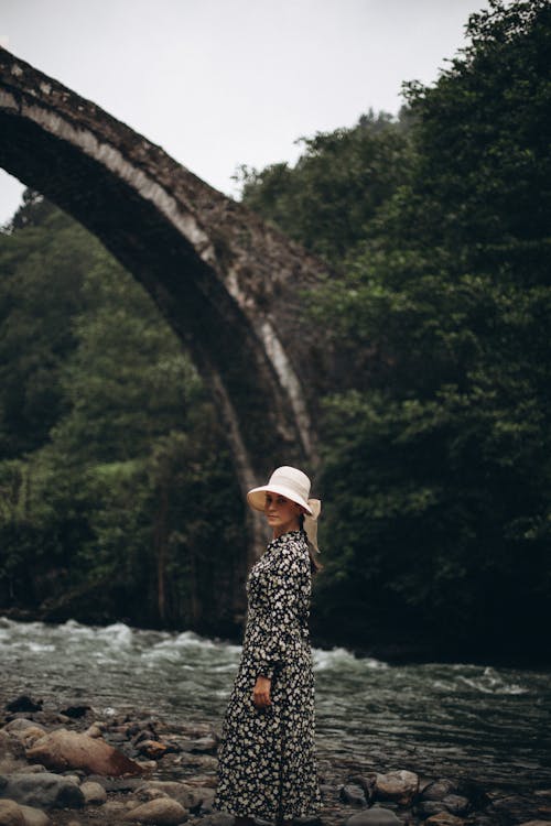 Woman in Sunhat with Ribbon by River