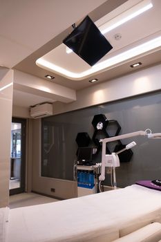 A clean and modern hospital room with advanced medical equipment and lighting.