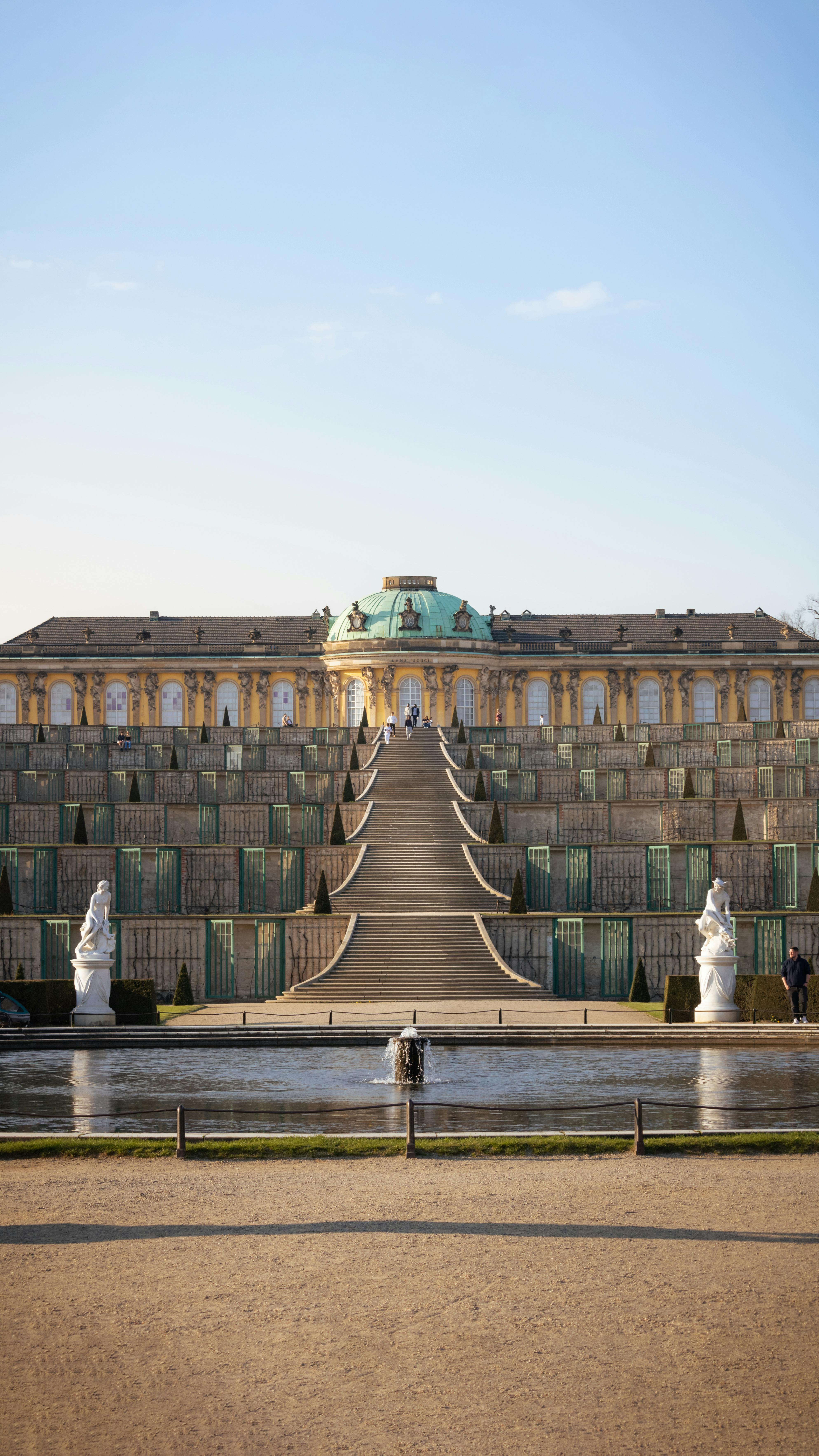 a large building with a fountain in front of it