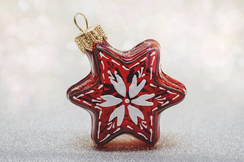 Free Red and White Hanging Ornament on Gray Surface Stock Photo