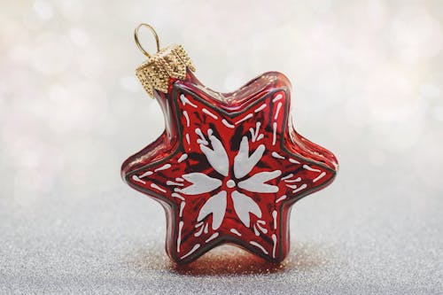 Red and White Hanging Ornament on Gray Surface