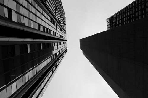 Free Black and white perspective view of urban skyscrapers reaching toward the sky. Stock Photo