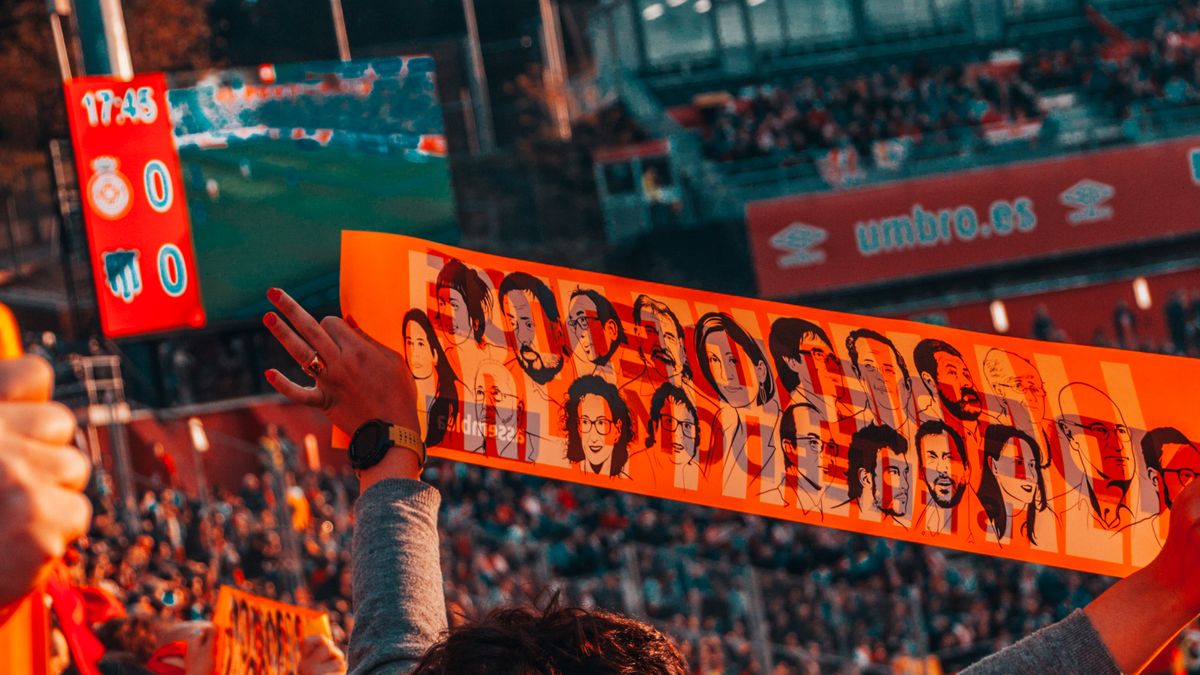 Crowd of soccer supporters watching a game from the stands