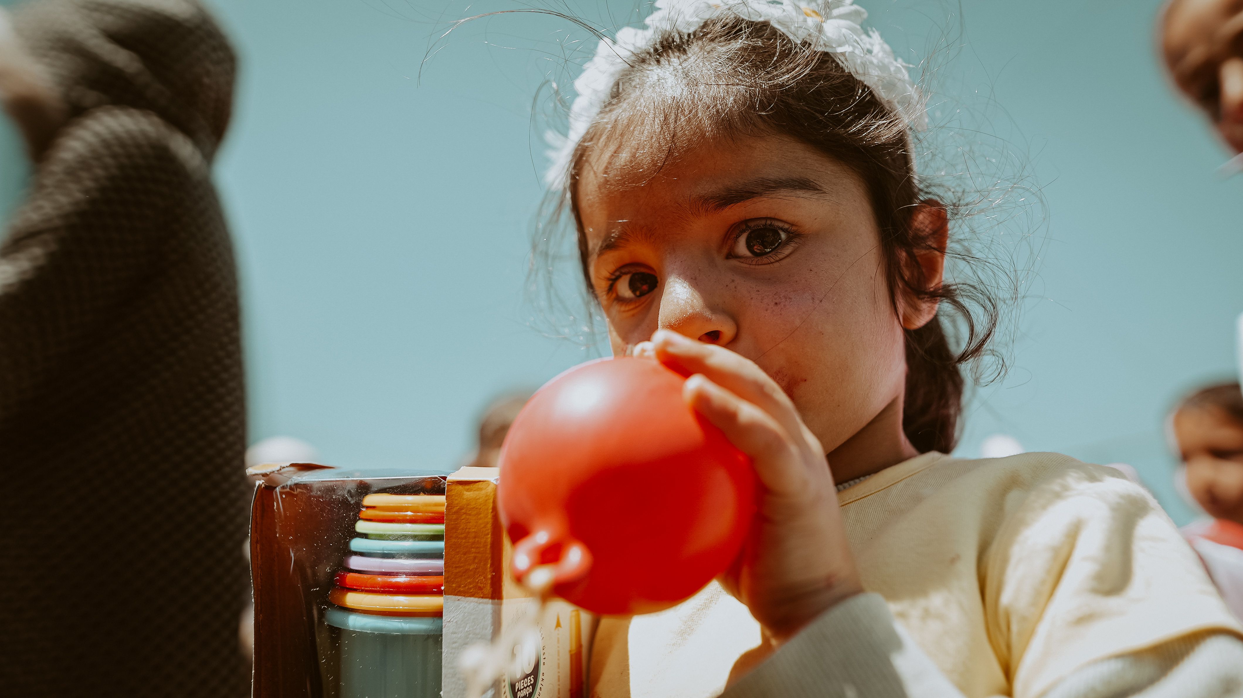 Girl Inflating Balloon · Free Stock Photo