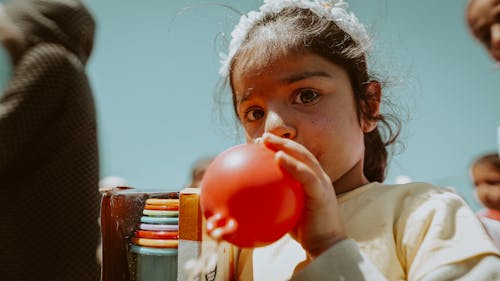 Girl Inflating Balloon