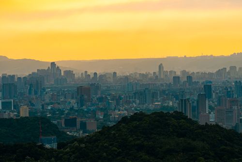 Free Captivating aerial view of a sprawling cityscape under a dramatic yellow sky at sunset. Stock Photo