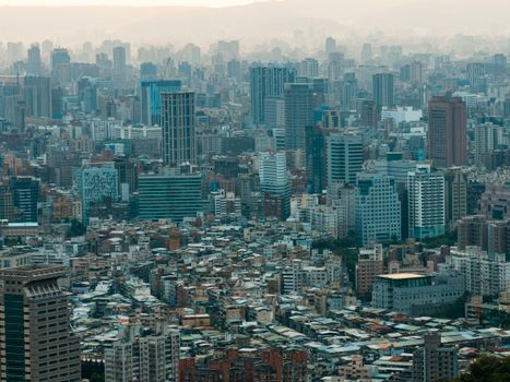 Aerial view of a bustling cityscape with a blend of skyscrapers and residential buildings.