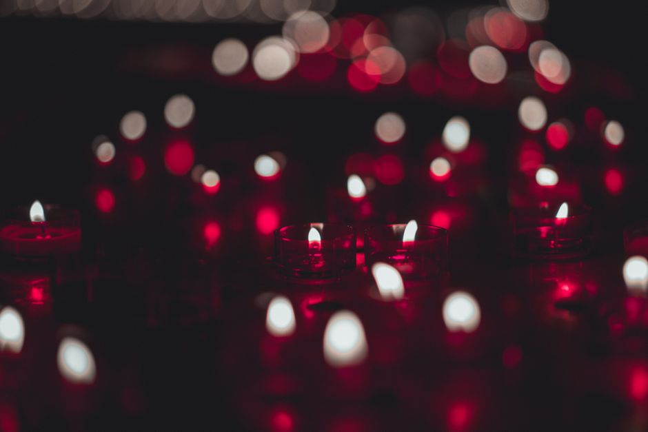 A captivating image of candle flames with red and white bokeh, creating a warm and intimate ambiance.