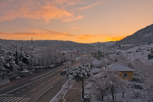 Snow in Village at Sunset