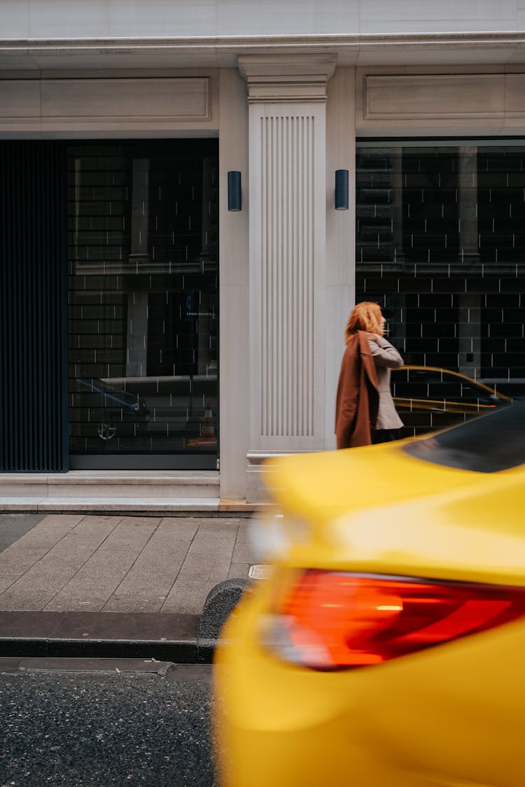 Woman Walking City Street With Yellow Taxi