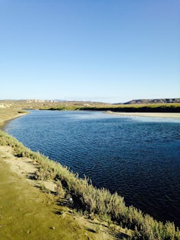 A picturesque river scene under a clear blue sky, perfect for nature and travel themes.